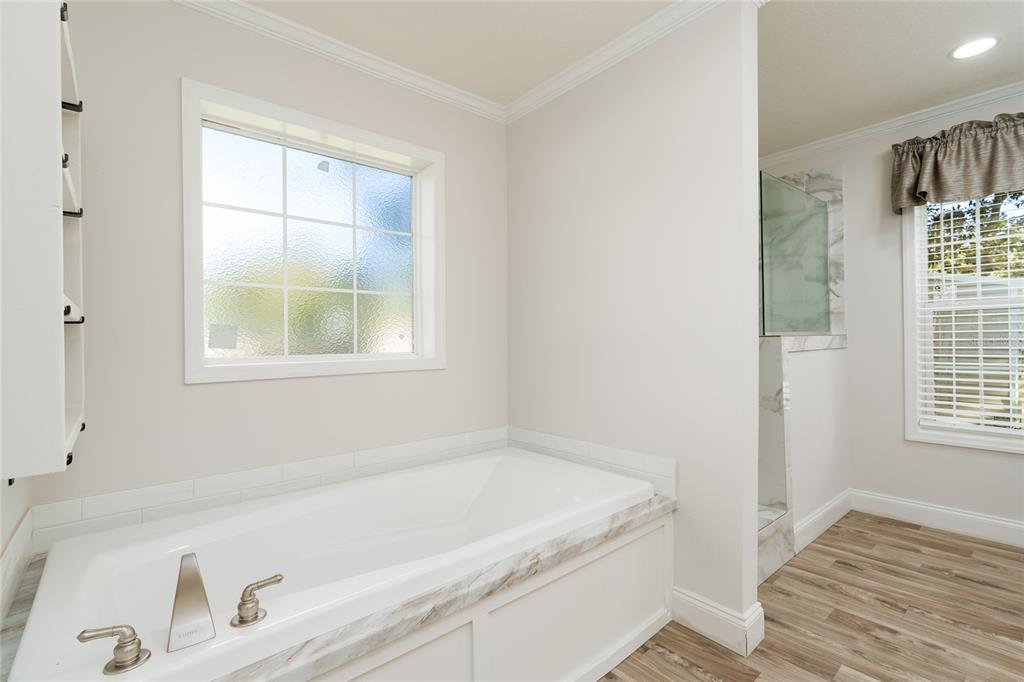 689 Eagle Watch Road Oak Hill, FL 32759 - Photo 17 of 32 a bath tub sitting next to a window