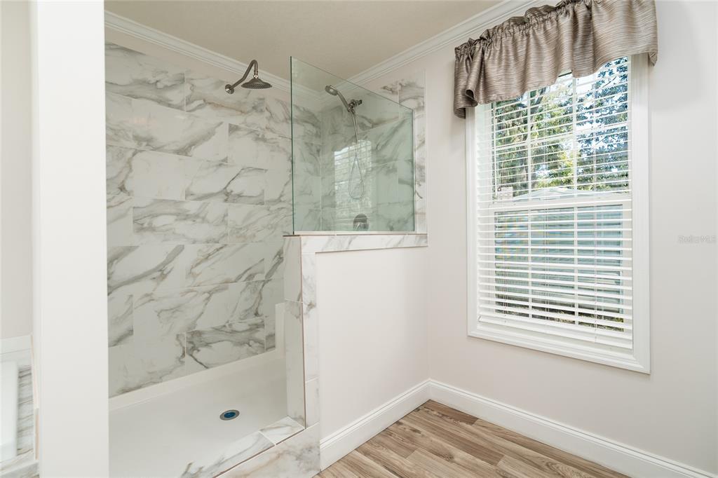 689 Eagle Watch Road Oak Hill, FL 32759 - Photo 18 of 32 a bathroom with a bathtub and shower