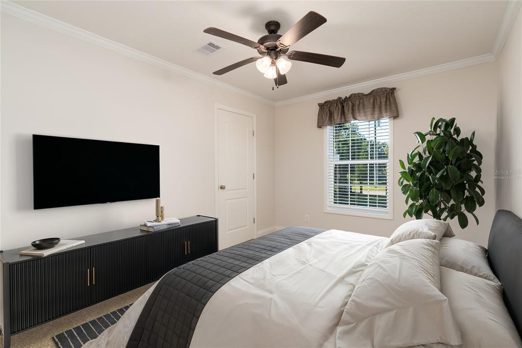 689 Eagle Watch Road Oak Hill, FL 32759 - Photo 20 of 32 a bedroom with a bed and a flat screen tv