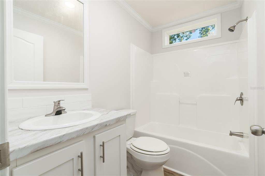689 Eagle Watch Road Oak Hill, FL 32759 - Photo 21 of 32 a bathroom with a sink and a mirror