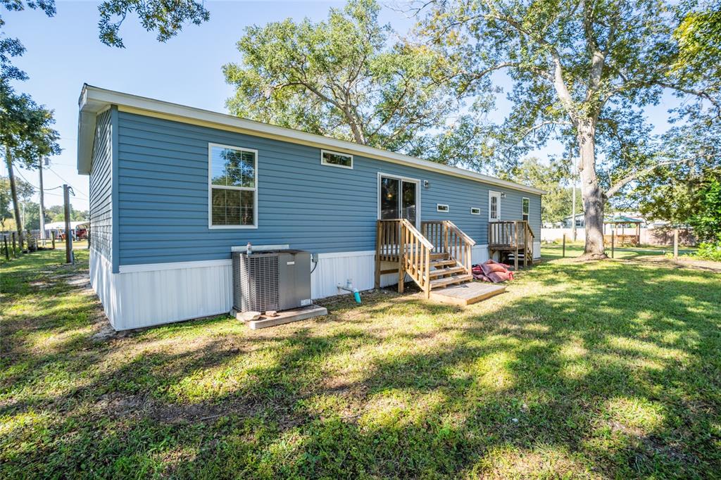 689 Eagle Watch Road Oak Hill, FL 32759 - Photo 25 of 32 a view of a backyard with a patio