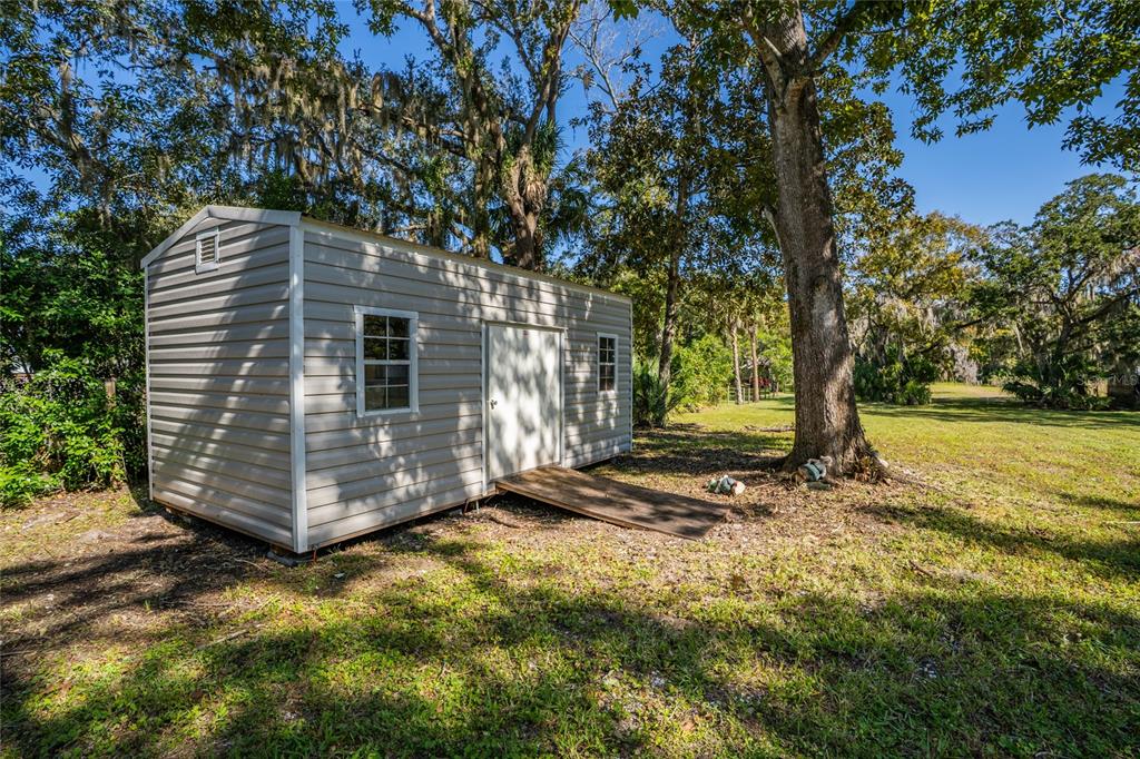 689 Eagle Watch Road Oak Hill, FL 32759 - Photo 26 of 32 a view of a house with a yard