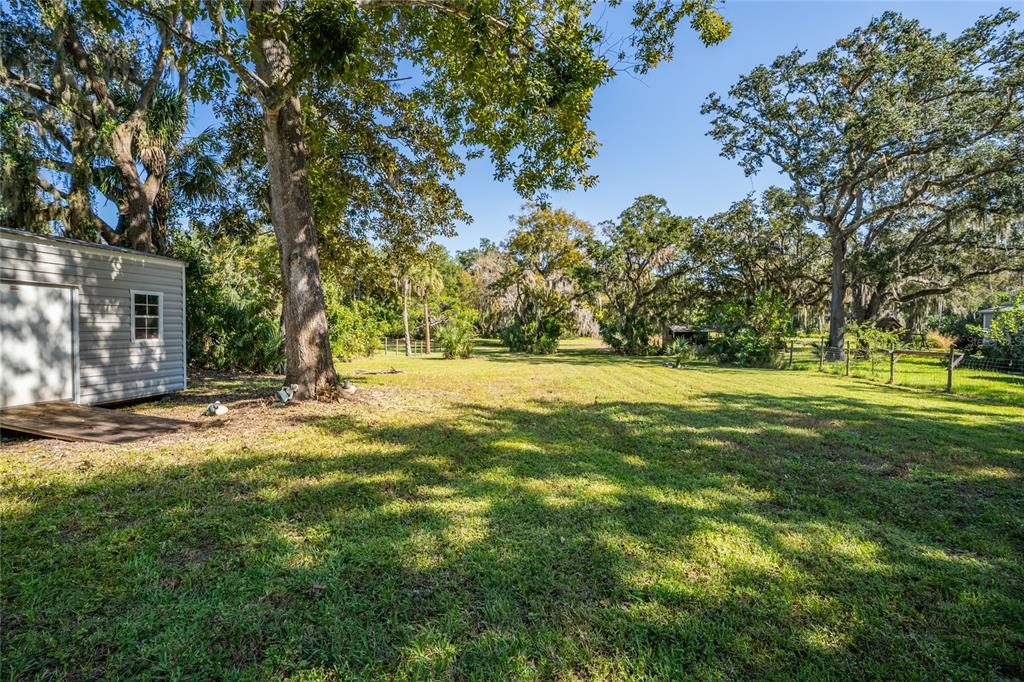 689 Eagle Watch Road Oak Hill, FL 32759 - Photo 27 of 32 a view of outdoor space with garden and trees