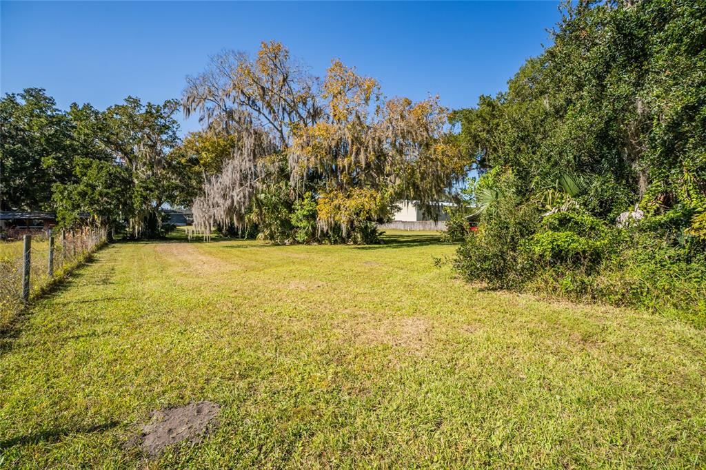 689 Eagle Watch Road Oak Hill, FL 32759 - Photo 30 of 32 a view of a yard with an outdoor space