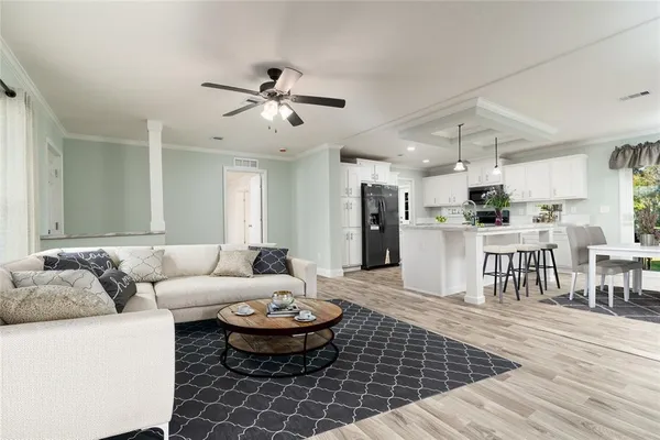 a living room with furniture and kitchen view