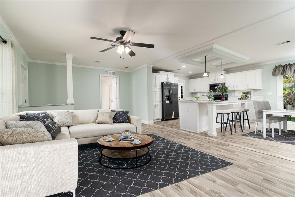 689 Eagle Watch Road Oak Hill, FL 32759 - Photo 3 of 32 a living room with furniture and kitchen view