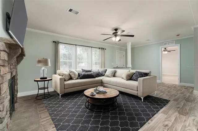 a living room with furniture a large window and a flat screen tv