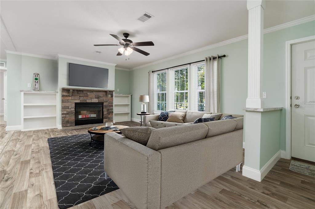 689 Eagle Watch Road Oak Hill, FL 32759 - Photo 5 of 32 a living room with furniture and a fireplace