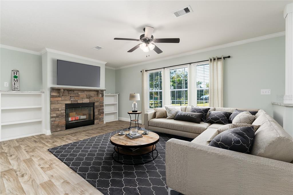 689 Eagle Watch Road Oak Hill, FL 32759 - Photo 6 of 32 a living room with furniture and a fireplace