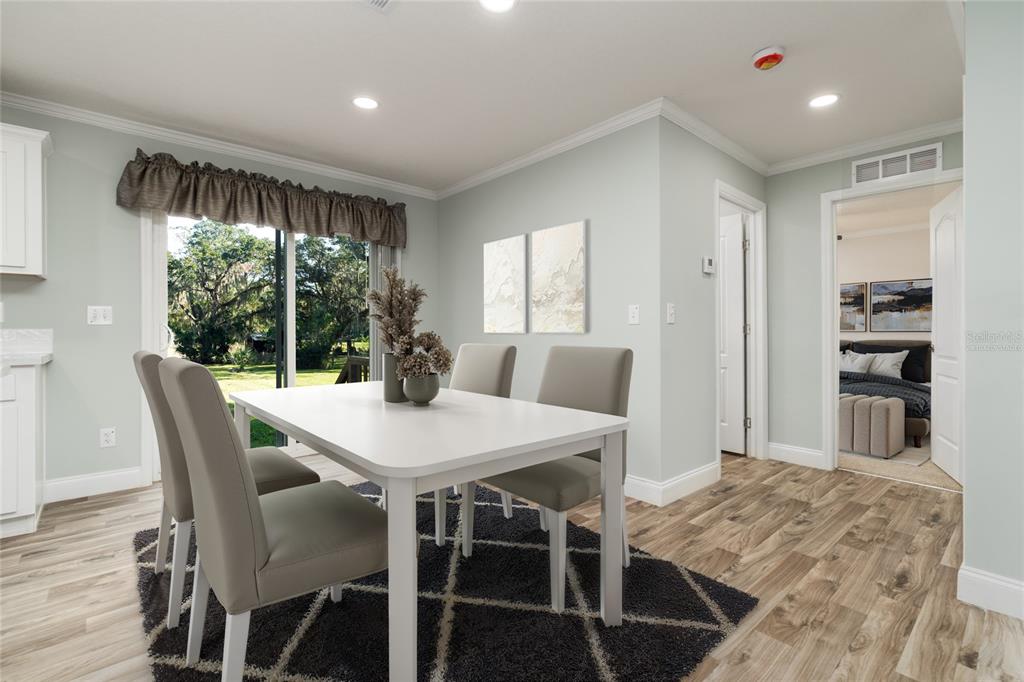 689 Eagle Watch Road Oak Hill, FL 32759 - Photo 7 of 32 a view of a dining room with furniture and a window