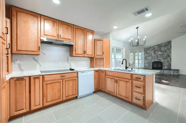 a view of house with backyard and glass windows