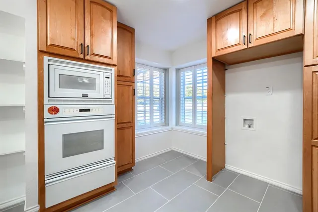 a kitchen with stainless steel appliances granite countertop a sink and cabinets
