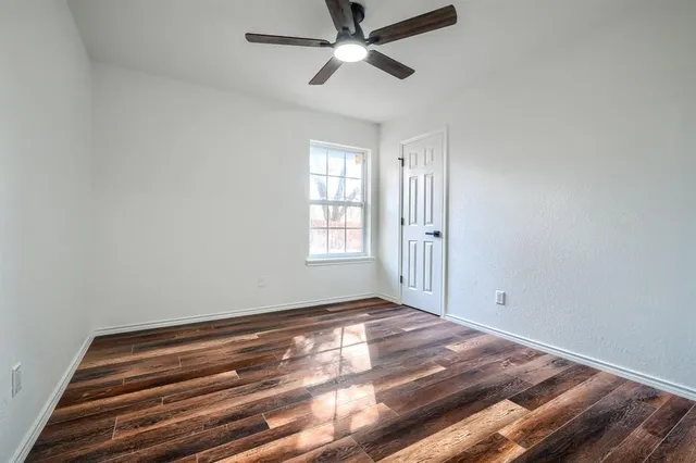 a spacious bedroom with a bed and a flat screen tv