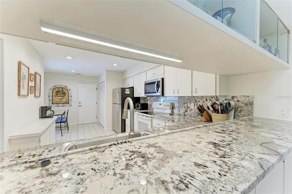 a kitchen with a sink a stove and refrigerator