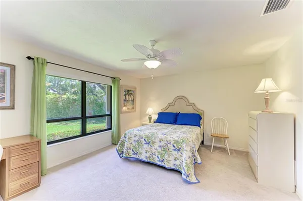 a bed sitting in a bedroom next to a window