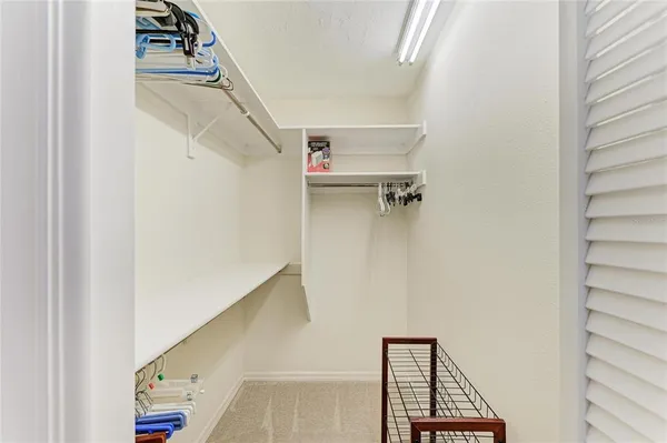 a spacious bathroom with a granite countertop sink a toilet and a mirror