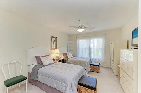 a bedroom with a bed and a television