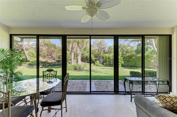 a living room with furniture and a floor to ceiling window