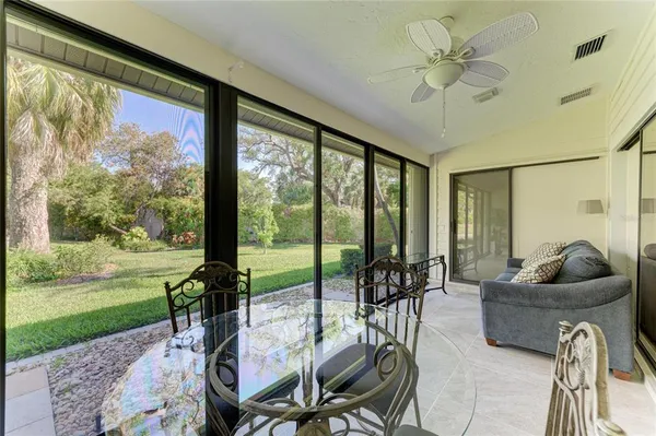 a living room with furniture and a floor to ceiling window