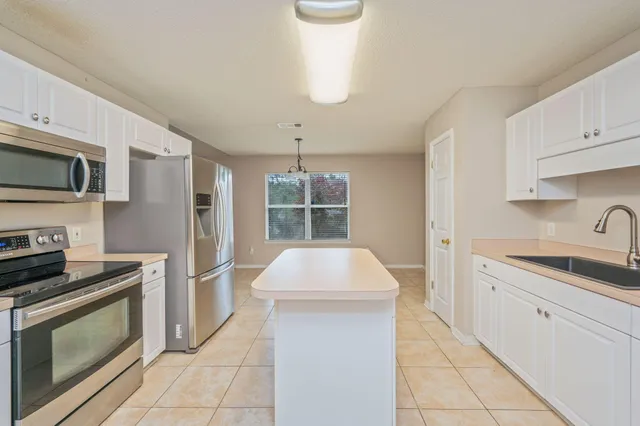 a kitchen with a sink stove and microwave