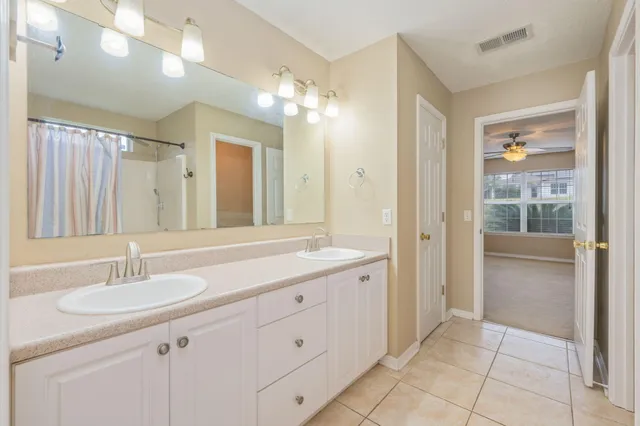 a bathroom with a sink vanity and a mirror