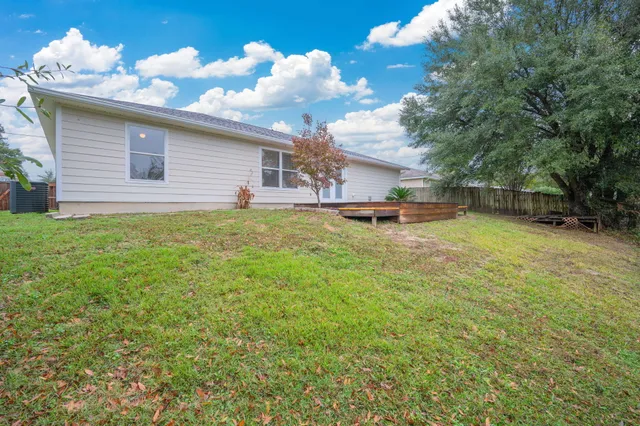 a view of a backyard with a large tree