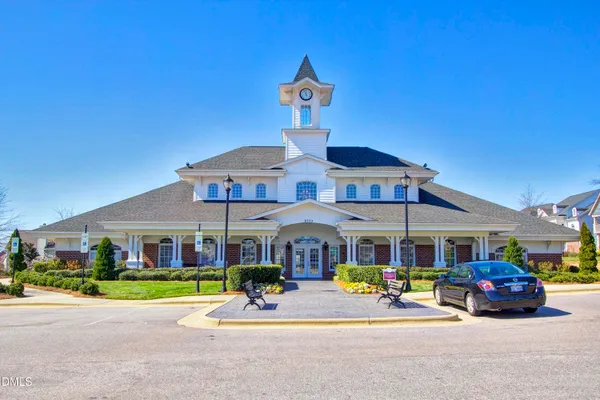 a front view of building with cars parked
