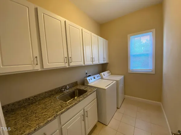 a view of a storage and utility room with a sink