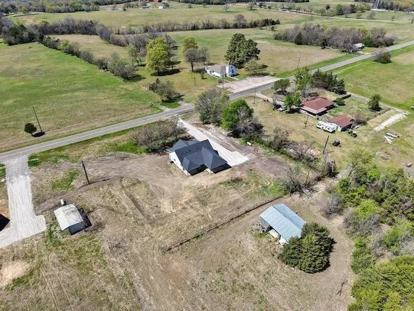 an aerial view of a house with a yard