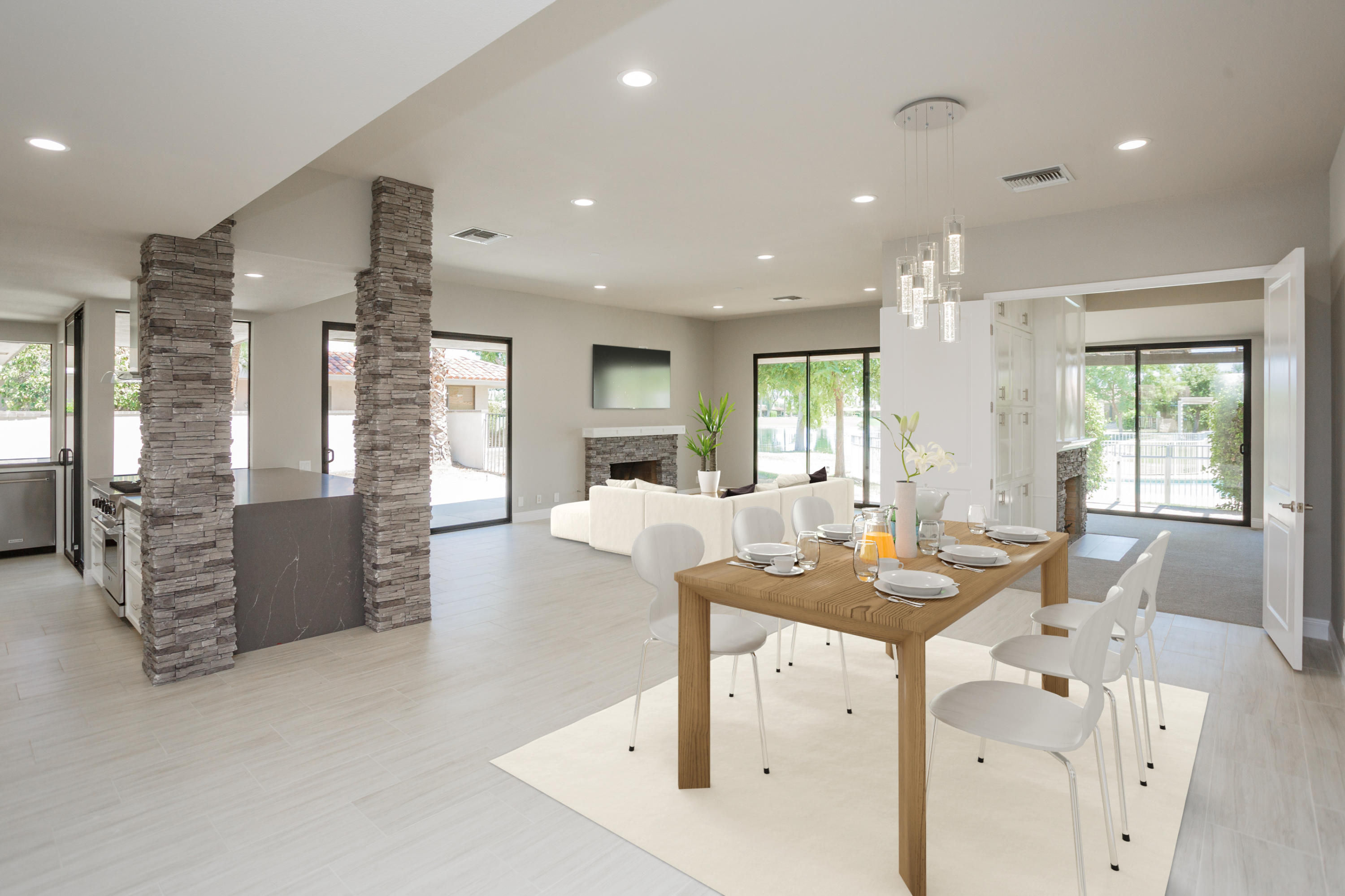 49 Columbia Drive Rancho Mirage, CA 92270 - Photo 16 of 52 a dining hall with stainless steel appliances kitchen island granite countertop a refrigerator a sink a dining table and chairs
