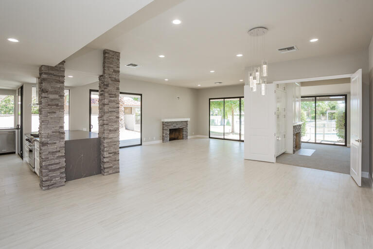 49 Columbia Drive Rancho Mirage, CA 92270 - Photo 17 of 52 a view of a big room with windows and chandelier