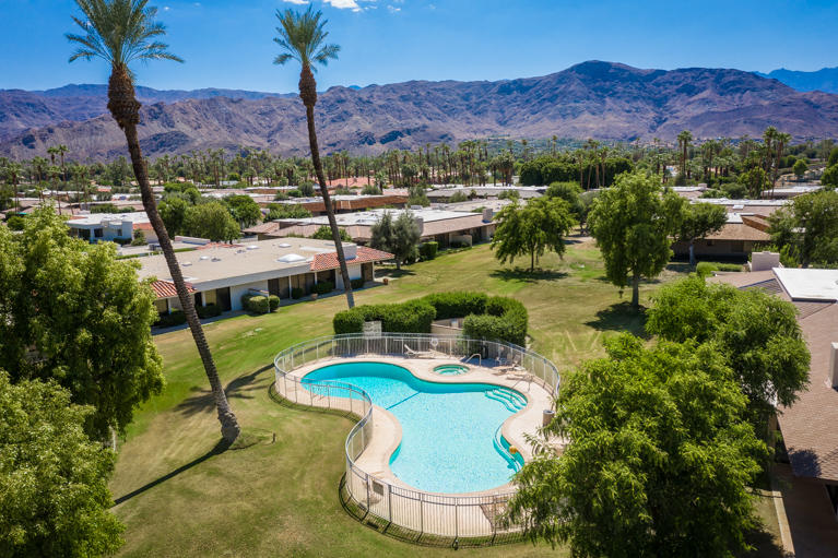 49 Columbia Drive Rancho Mirage, CA 92270 - Photo 3 of 52 a view of a swimming pool with a yard and mountain view