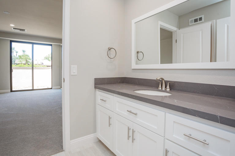 49 Columbia Drive Rancho Mirage, CA 92270 - Photo 30 of 52 a bathroom with a sink and two mirror