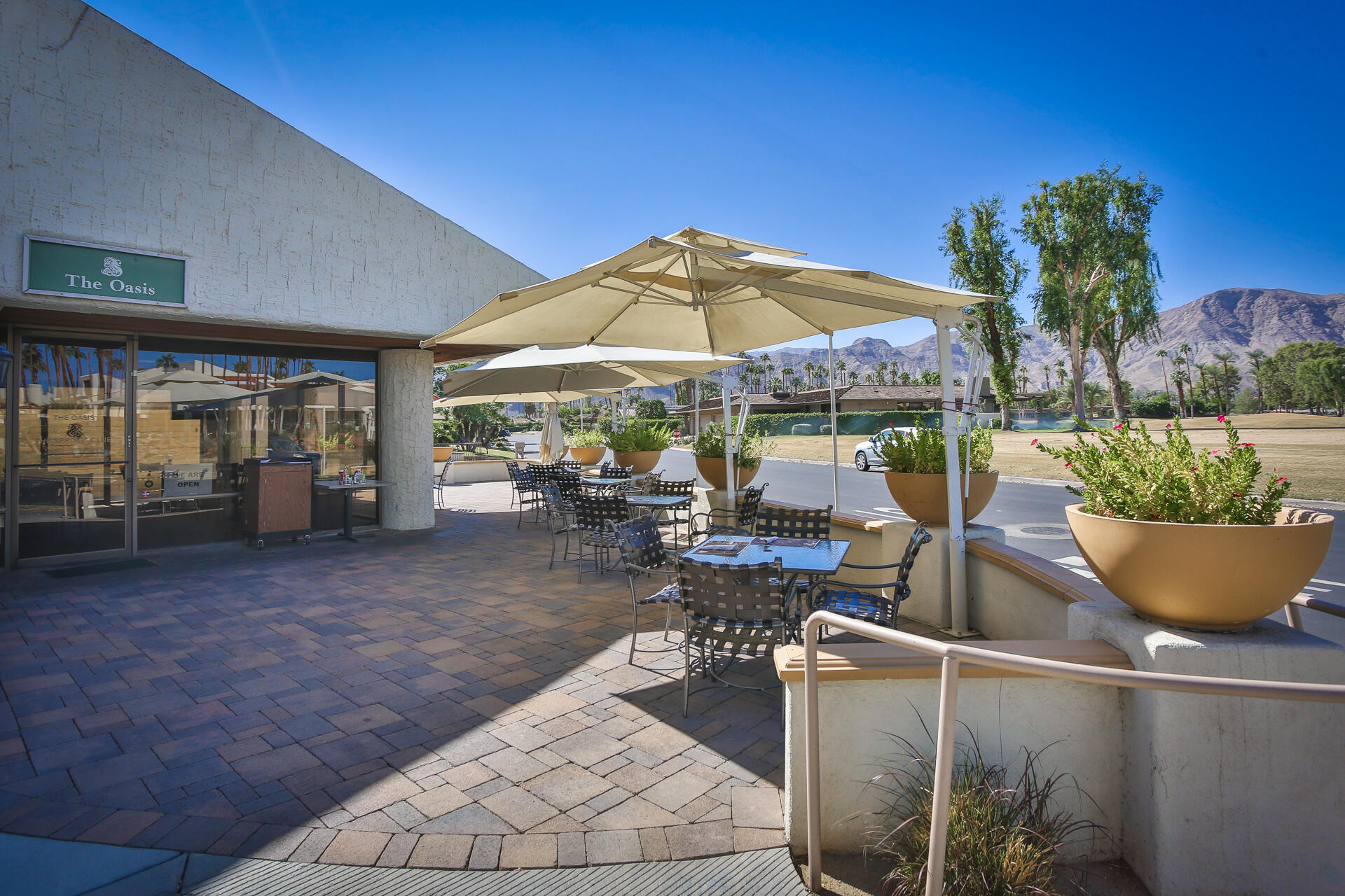 49 Columbia Drive Rancho Mirage, CA 92270 - Photo 48 of 52 a view of a patio with chairs and table under an umbrella