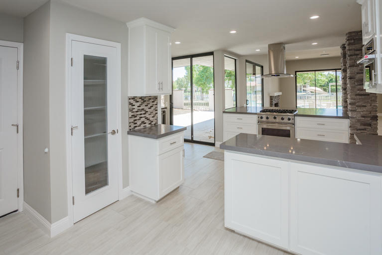 49 Columbia Drive Rancho Mirage, CA 92270 - Photo 9 of 52 a large living room with stainless steel appliances granite countertop furniture and a large window