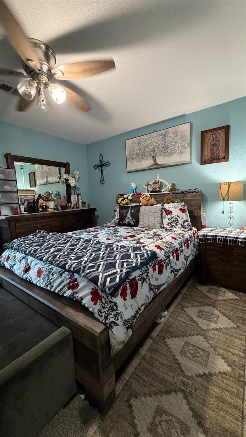 3105 Keller Street Modesto, CA 95355 - Photo 17 of 25 a bedroom with bed and lamp