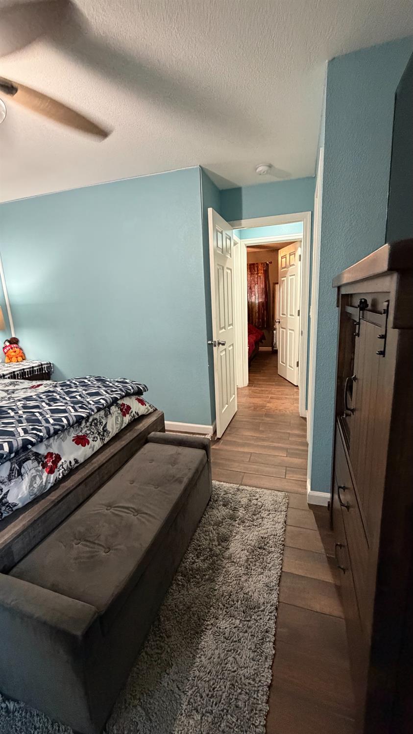 3105 Keller Street Modesto, CA 95355 - Photo 22 of 25 a bedroom with bed and walk in closet