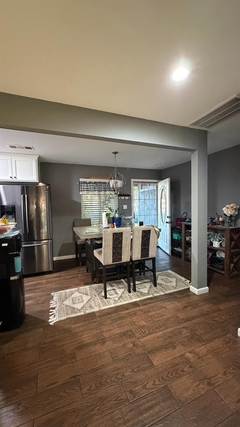 3105 Keller Street Modesto, CA 95355 - Photo 3 of 25 a living room with furniture a dining table and chairs with kitchen view