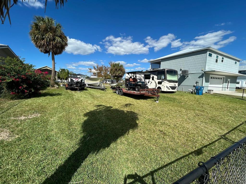 4977 Cedarbrook Lane Hernando Beach, FL 34607 - Photo 18 of 25 a view of a yard with table and chairs