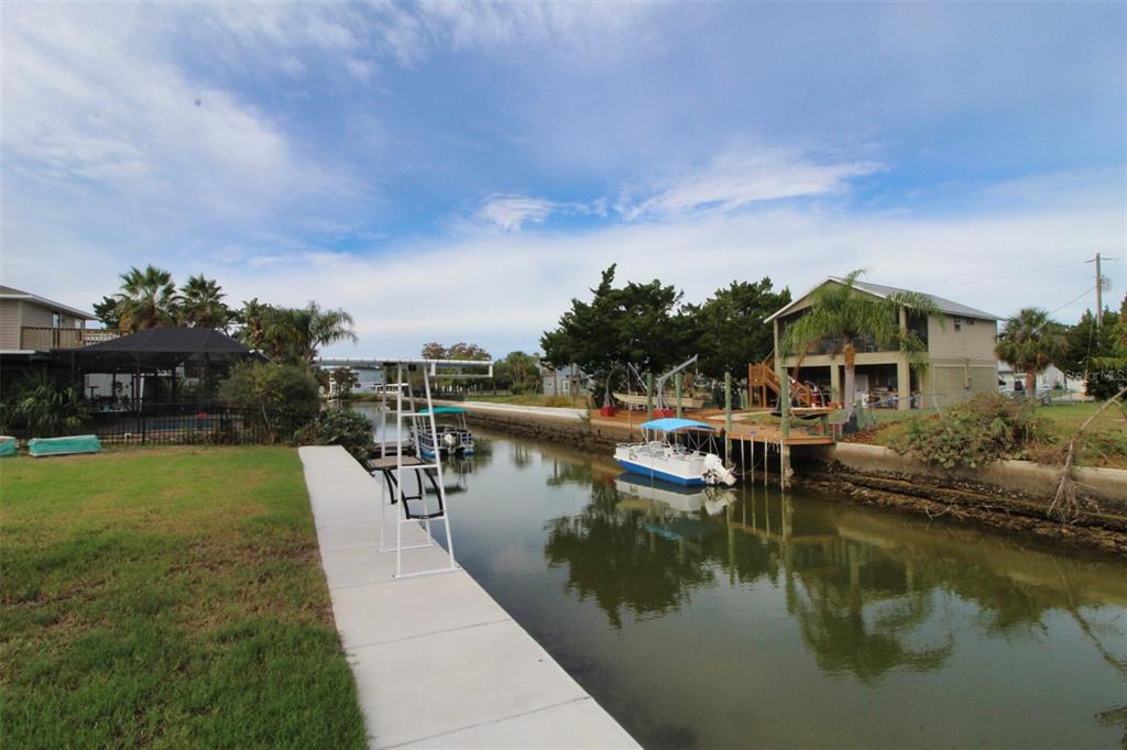 4977 Cedarbrook Lane Hernando Beach, FL 34607 - Photo 3 of 25 a view of a lake with houses in the back