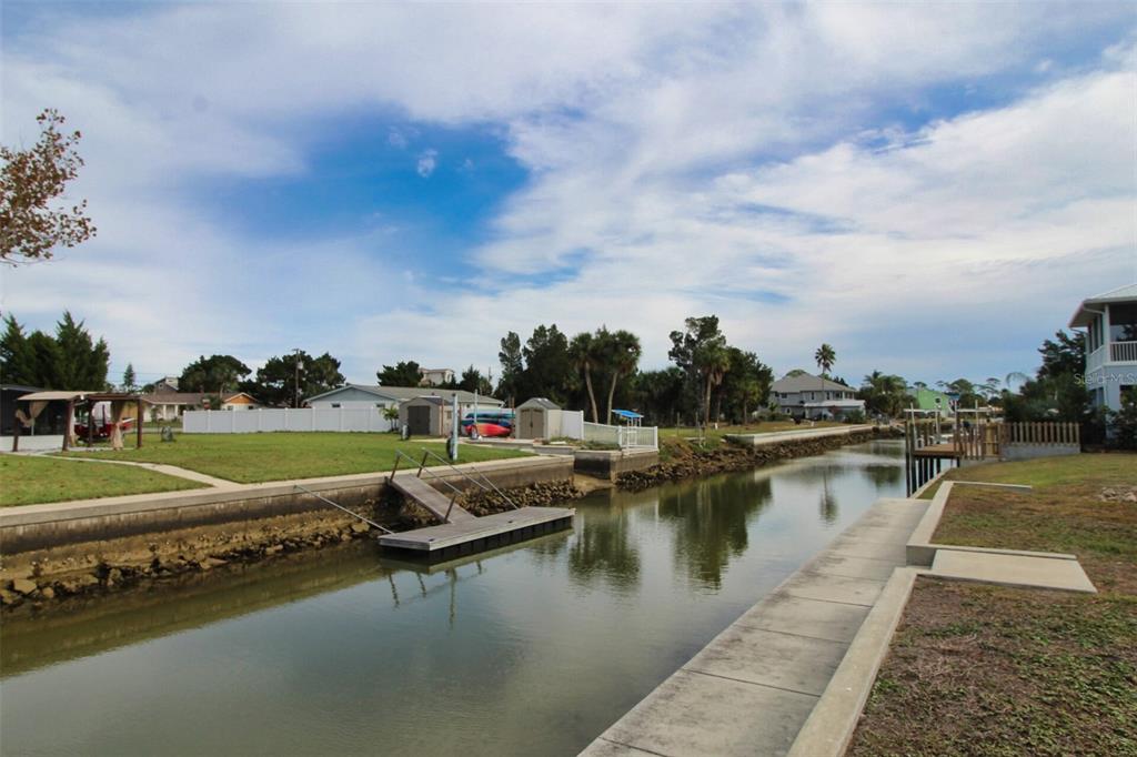 4977 Cedarbrook Lane Hernando Beach, FL 34607 - Photo 5 of 25 a view of a lake with a yard