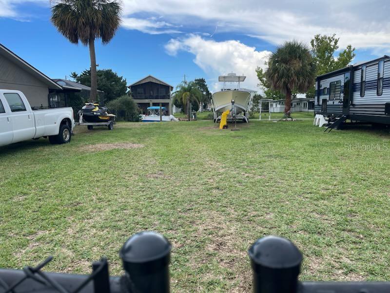 4977 Cedarbrook Lane Hernando Beach, FL 34607 - Photo 9 of 25 a view of a backyard with furniture and a fire pit