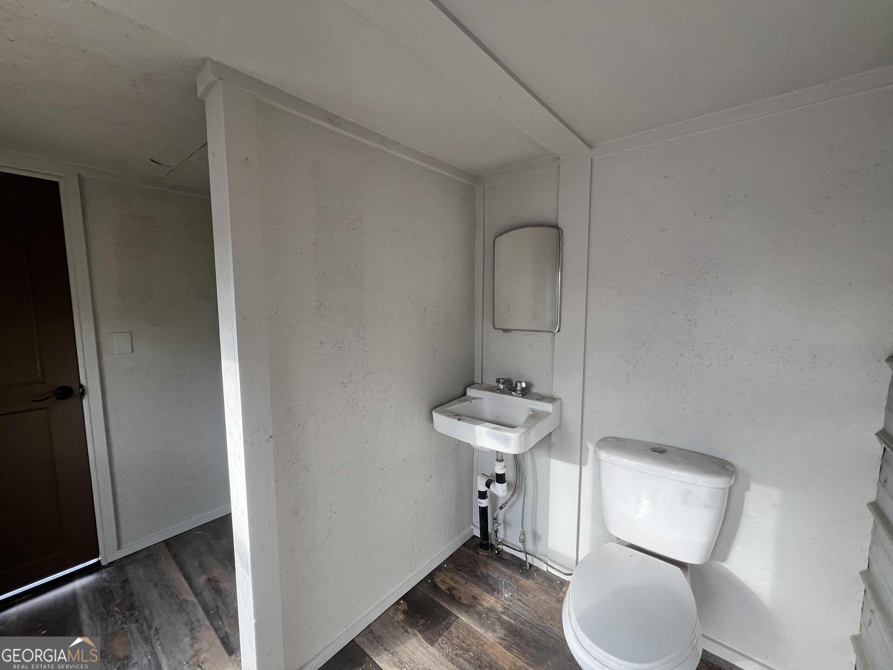 343 Morrison Street Mount Vernon, GA 30445 - Photo 13 of 22 a bathroom with a toilet sink and mirror