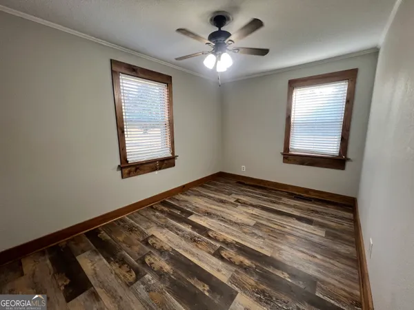 a view of a room with a ceiling fan and a window