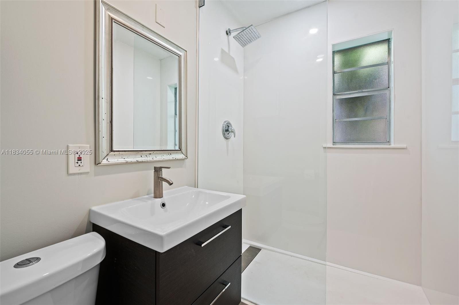 7865 Southwest 57th Avenue, Unit 48D South Miami, FL 33143 - Photo 12 of 22 a bathroom with a sink and a toilet