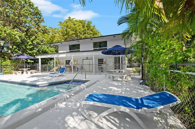 a view of a house with backyard and sitting area
