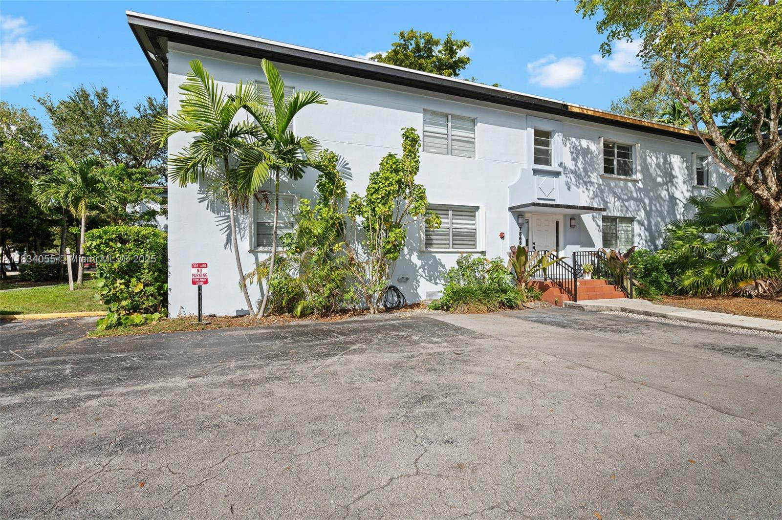 7865 Southwest 57th Avenue, Unit 48D South Miami, FL 33143 - Photo 20 of 22 a front view of a house with a yard and a garage