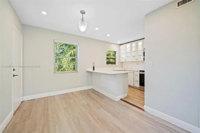 a view of kitchen with granite countertop cabinets and wooden floor