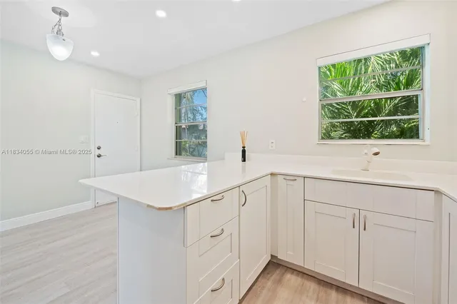 a bathroom with a sink and a window