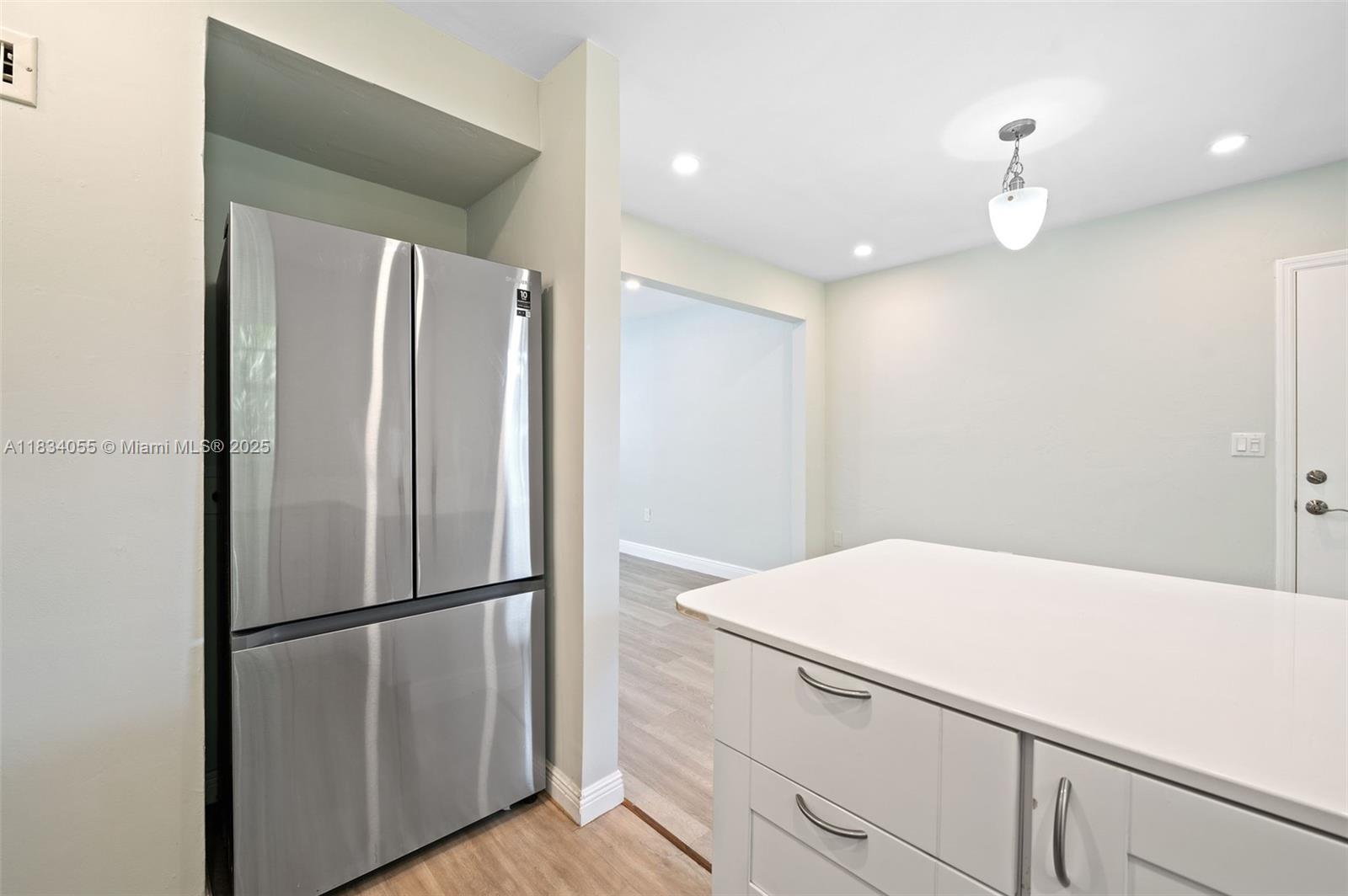 7865 Southwest 57th Avenue, Unit 48D South Miami, FL 33143 - Photo 8 of 22 a kitchen with metallic refrigerator freezer and a dishwasher